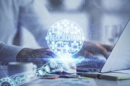 Blockchain theme hologram with man working on computer on background. Concept of crypto chain....