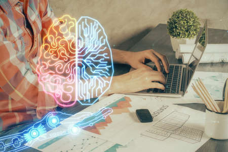 Man with computer background with brain theme hologram. Concept of brainstorm. Double exposure.