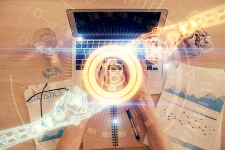 Double exposure of woman hands working on computer and blockchain theme hologram drawing. Top View....