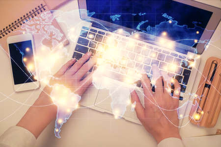 Double exposure of woman hands working on computer and financial theme hologram drawing. Top View....