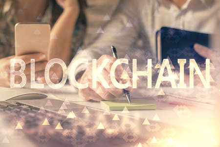 Double exposure of man and woman working together and crypto finance theme hologram. Blockchain...