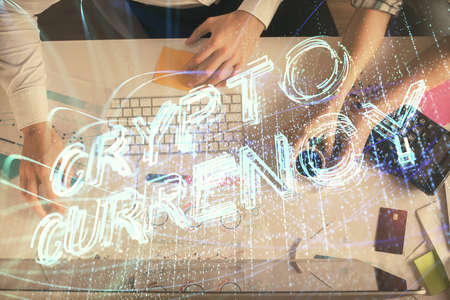Double exposure of man and woman working together and crypto theme hologram drawing. Computer...