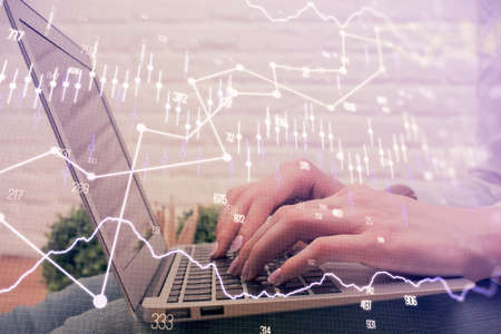 Multi exposure of woman hands typing on computer and forex chart hologram drawing. Stock market...