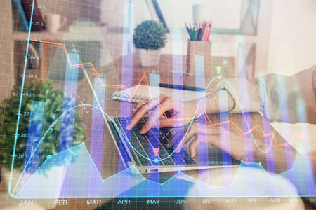 Double exposure of woman hands typing on computer and forex chart hologram drawing. Stock market...