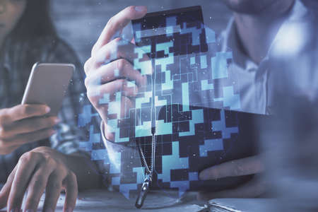 Double exposure of man and woman on-line shopping holding a credit card and data theme hologram...