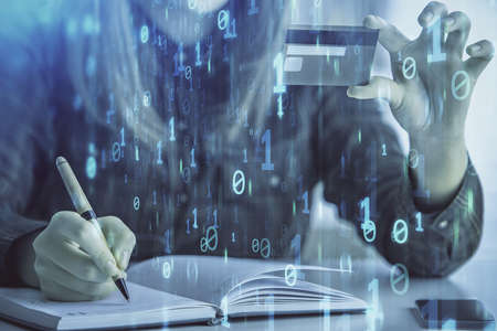 Double exposure of woman on-line shopping holding a credit card and data theme hologram drawing....