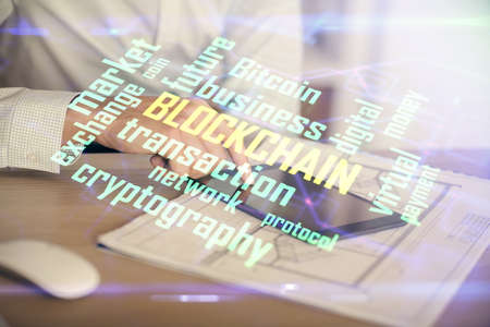 Double exposure of mans hands holding and using a phone and crypto currency blockchain theme drawing.の写真素材