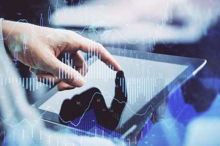 Multi exposure of mans hands holding and using a phone and financial chart drawing. Market analysis...