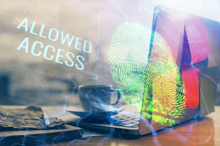 Computer on desktop in office with finger print drawing. Double exposure. Concept of business data...