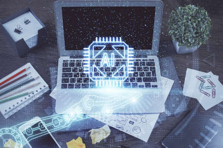 Double exposure of laptop computer and technology theme hologram. Concept of freelance work.