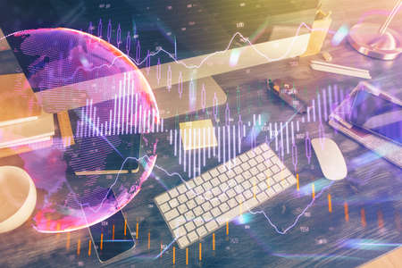 Double exposure of forex graph and work space with computer. Concept of international online...