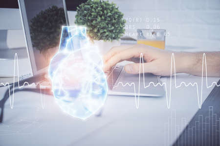 Heart drawing with man working on computer on background. Medical concept. Double exposure.