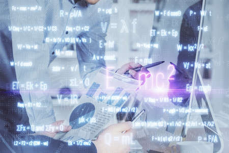 Science formula hologram with man working on computer on background. Education concept. Double...