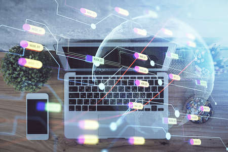 Double exposure of map hologram drawing over study table background with computer. Concept of...