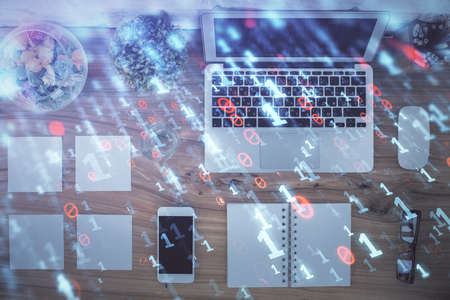 Double exposure of data theme drawing hologram over topview work table background with computer....