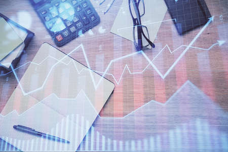 Double exposure of forex graph drawing and work table top veiw. Concept of financial analysis.