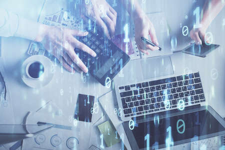 Double exposure of man and woman working together and data theme hologram drawing. Computer...