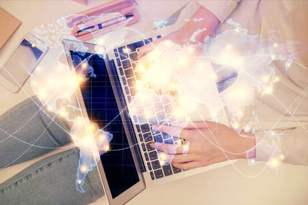Double exposure of woman hands working on computer and financial theme hologram drawing. Top View....