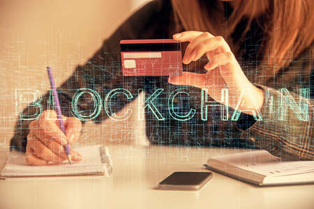 Multi exposure of woman on-line shopping holding a credit card and crypto theme drawing. Blockchain...