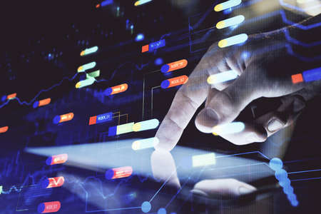 Double exposure of mans hand holding and using a digital device and data theme hologram drawing. Technology concept.の写真素材