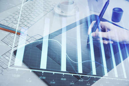 Double exposure of financial graph sketch hologram and woman holding and using a mobile device....