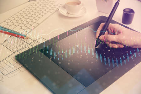Double exposure of financial graph sketch hologram and woman holding and using a mobile device....