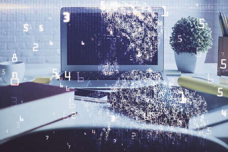 Computer on desktop in office with technology theme hologram. Double exposure. Tech concept.