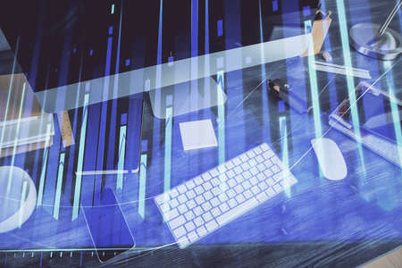 Double exposure of graph and financial info and work space with computer background. Concept of...