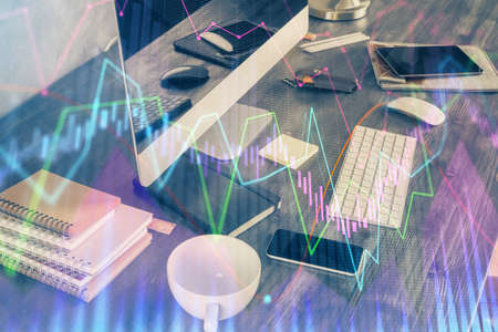 Multi exposure of chart and financial info and work space with computer background. Concept of international online trading.の写真素材