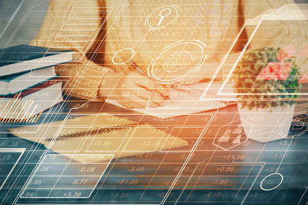 Double exposure of writing hands on background with data solution hologram on front. Technology...