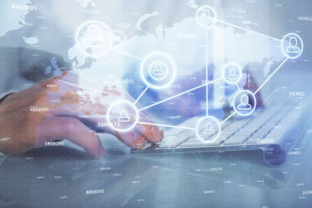 Social network theme hologram with businessman working on computer on background. Multi exposure.