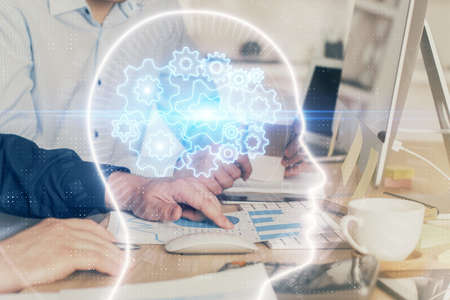 Man with computer background with brain theme hologram. Concept of brainstorm. Double exposure.
