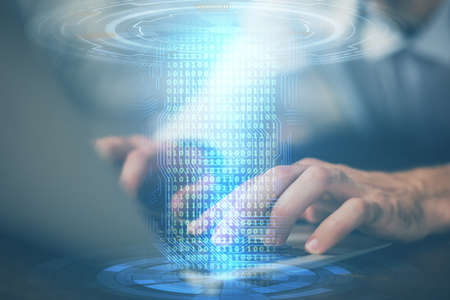Multi exposure of data internet theme hologram with man working on computer on background. Concept...