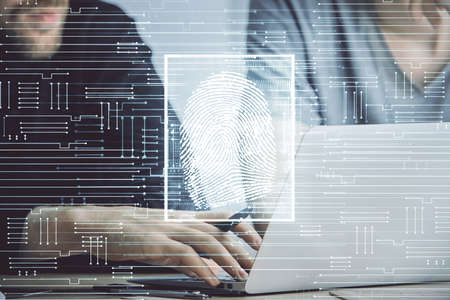 Fingerprint hologram with businessman working on computer on background. Security concept. Double exposure.の写真素材