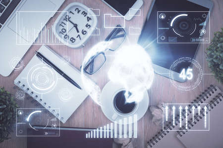 Double exposure of financial chart hologram over desktop with phone. Top view. Mobile trade platform...
