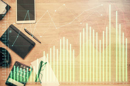 Double exposure of forex graph drawing and work table top veiw. Concept of financial analysis.