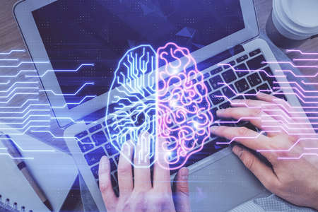 Double exposure of mans hands typing over computer keyboard and brain hologram drawing. Top view. Ai...