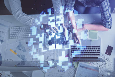 Double exposure of man and woman working together and data theme hologram drawing. Computer...
