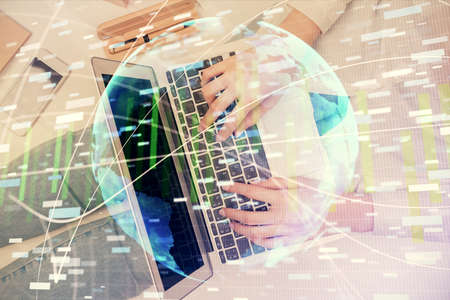 Double exposure of woman hands working on computer and financial theme hologram drawing. Top View....