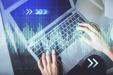 Double exposure of woman hands working on computer and forex chart hologram drawing. Top View....