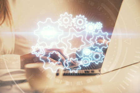 Multi exposure of woman hands typing on computer and business theme hologram drawing. Success...