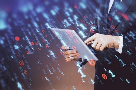 Double exposure of mans hand holding and using a digital device and data theme hologram drawing....