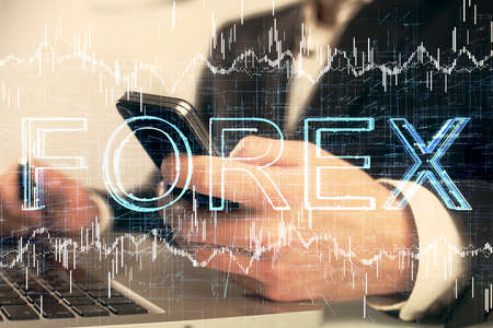 Multi exposure of mans hands holding and using a digital phone and forex graph drawing. Financial...