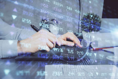 Double exposure of mans hands holding and using a phone and financial graph drawing. Analysis...