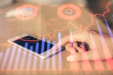 Double exposure of forex chart sketch hologram and woman holding and using a mobile device....