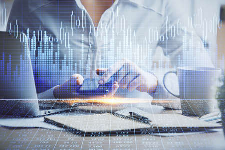 Double exposure of forex chart sketch hologram and woman holding and using a mobile device....