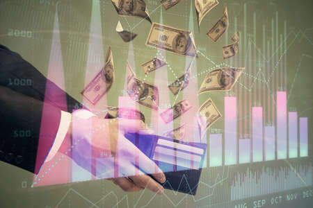 Multi exposure of financial graph drawing hologram and USA dollars bills and man hands. Analysis...