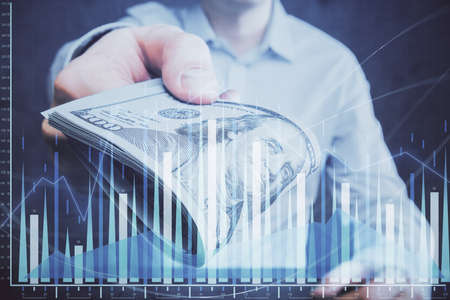 Multi exposure of financial graph drawing hologram and USA dollars bills and man hands. Analysis...