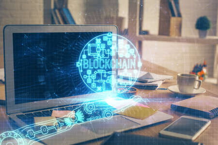 Multi exposure of blockchain theme hologram and table with computer background. Concept of bitcoin...