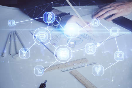 Man's hands working with notes background. Social networking scheme . Mixed media. Global business. Multi exposure.の写真素材